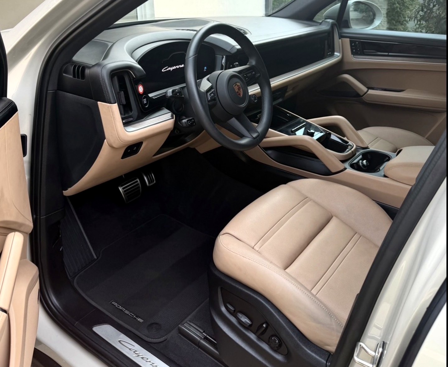 Freshly detailed Porsche Cayenne interior with striped carpet mats